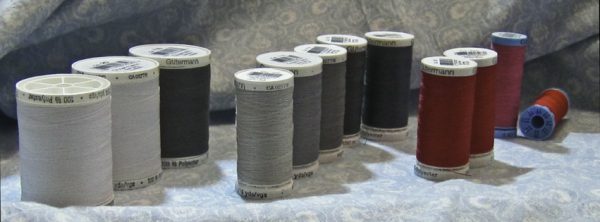 spools of thread and a length of blue&white printed cotton from Fabricland